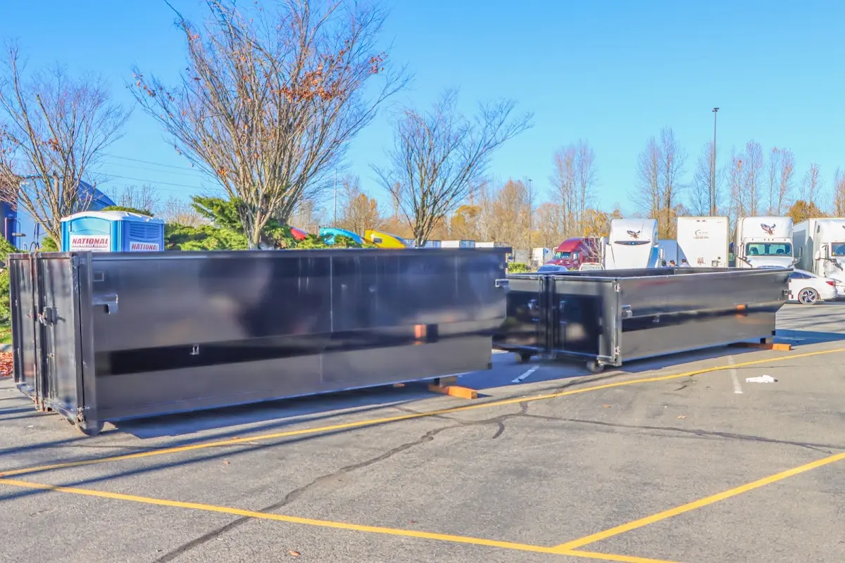 Professional dumpster rental service with roll-off container on residential driveway in Country Club